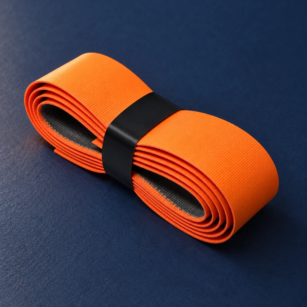 Orange folded replacement grip with a textured surface and black retaining band Orange folded replacement grip with a textured surface and black retaining band