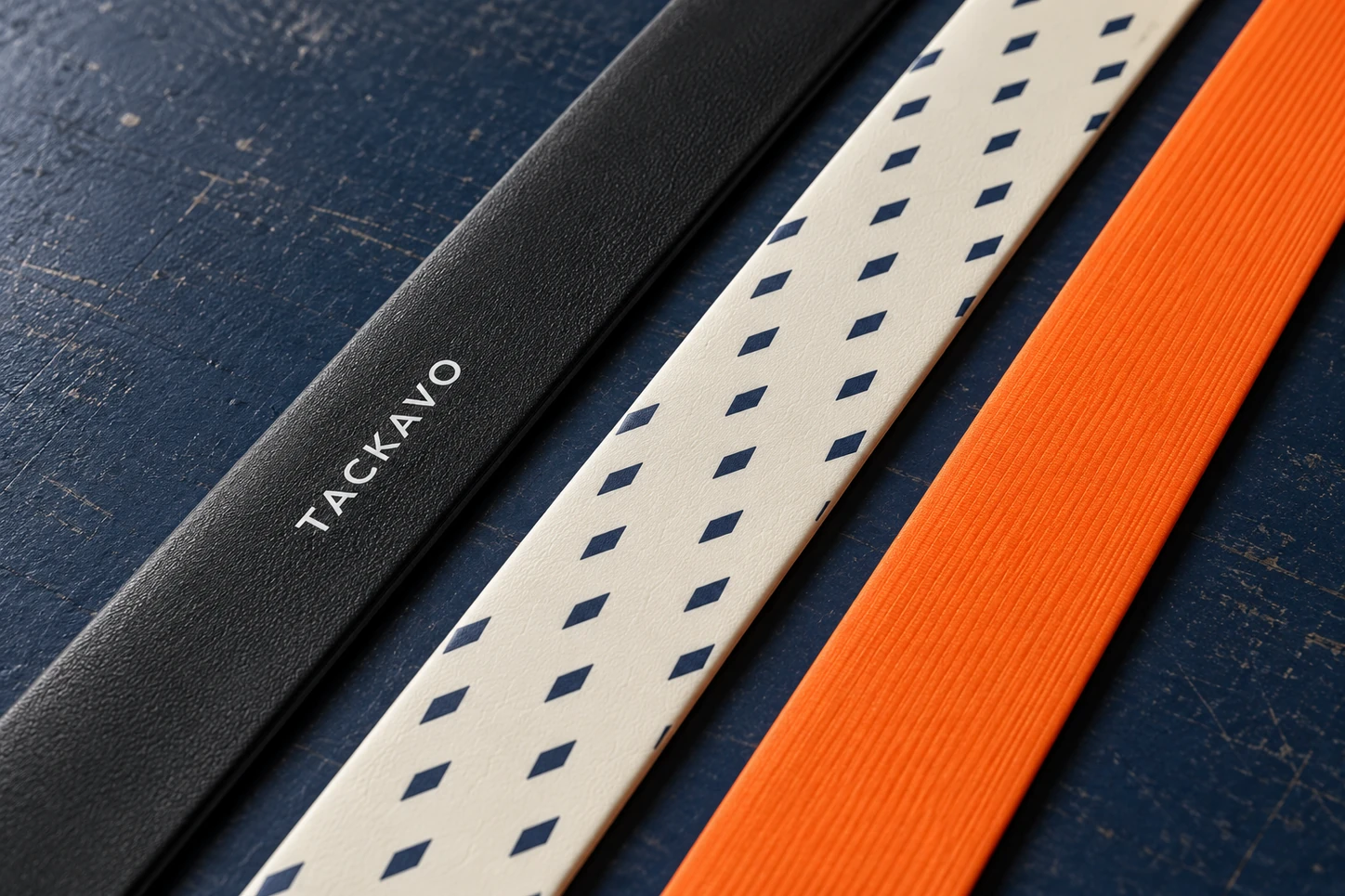 Tackavo logo printing and patterned grip strips on a navy sample table