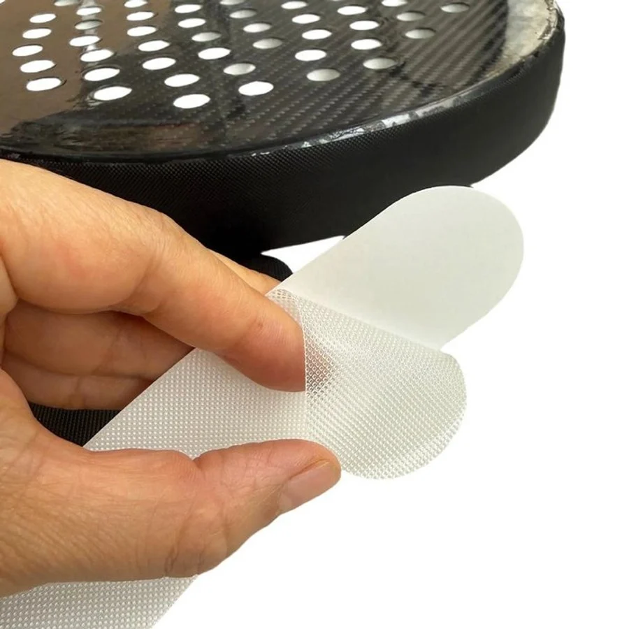 Transparent TPU padel frame protector being applied to a racket frame