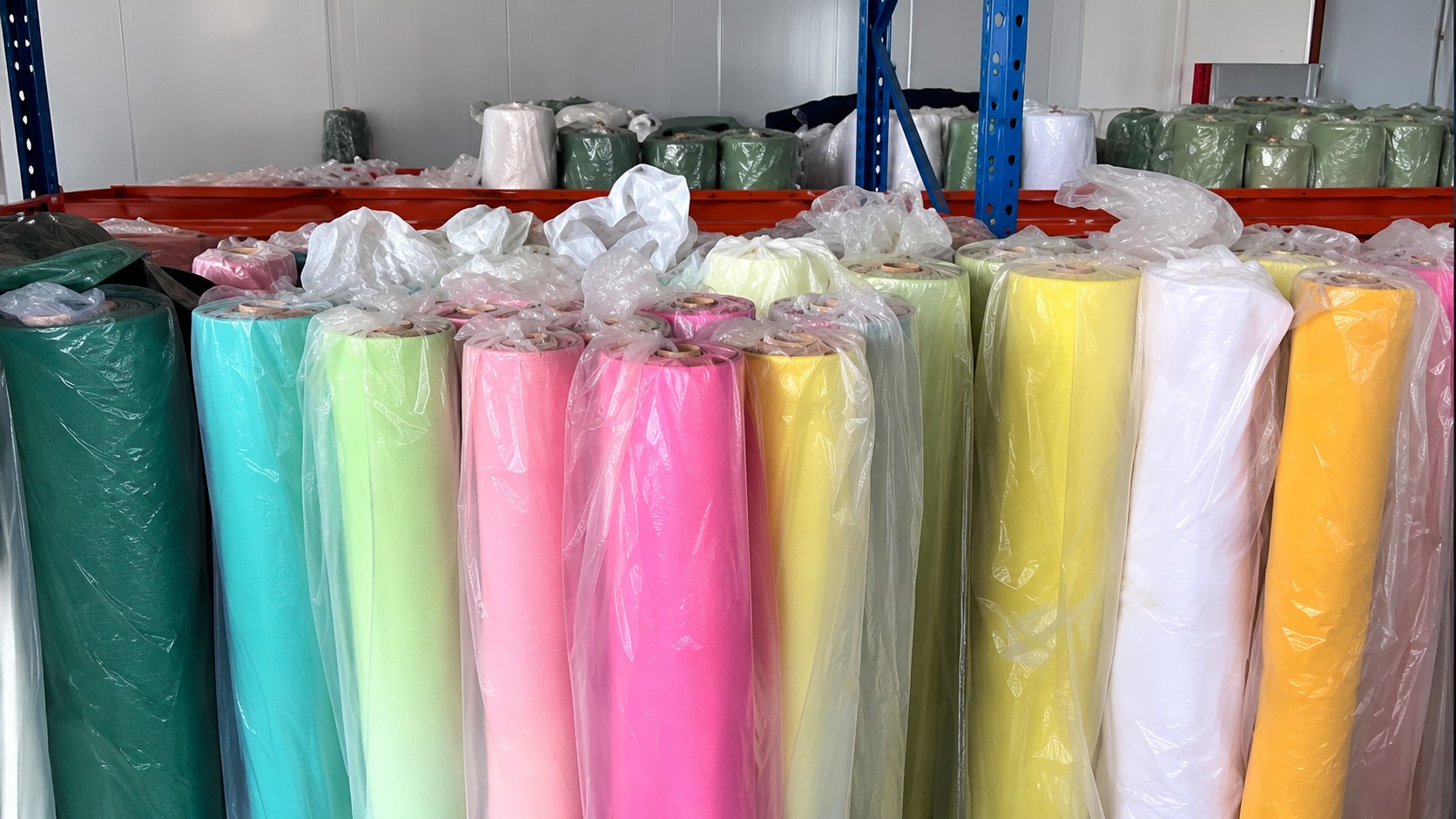 Upright rolls of material in multiple colors