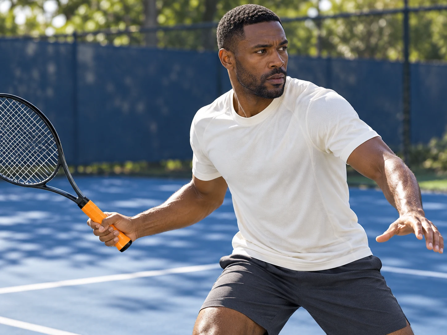 A tennis player holding a racket with OG-T06 orange high-tack durable overgrip