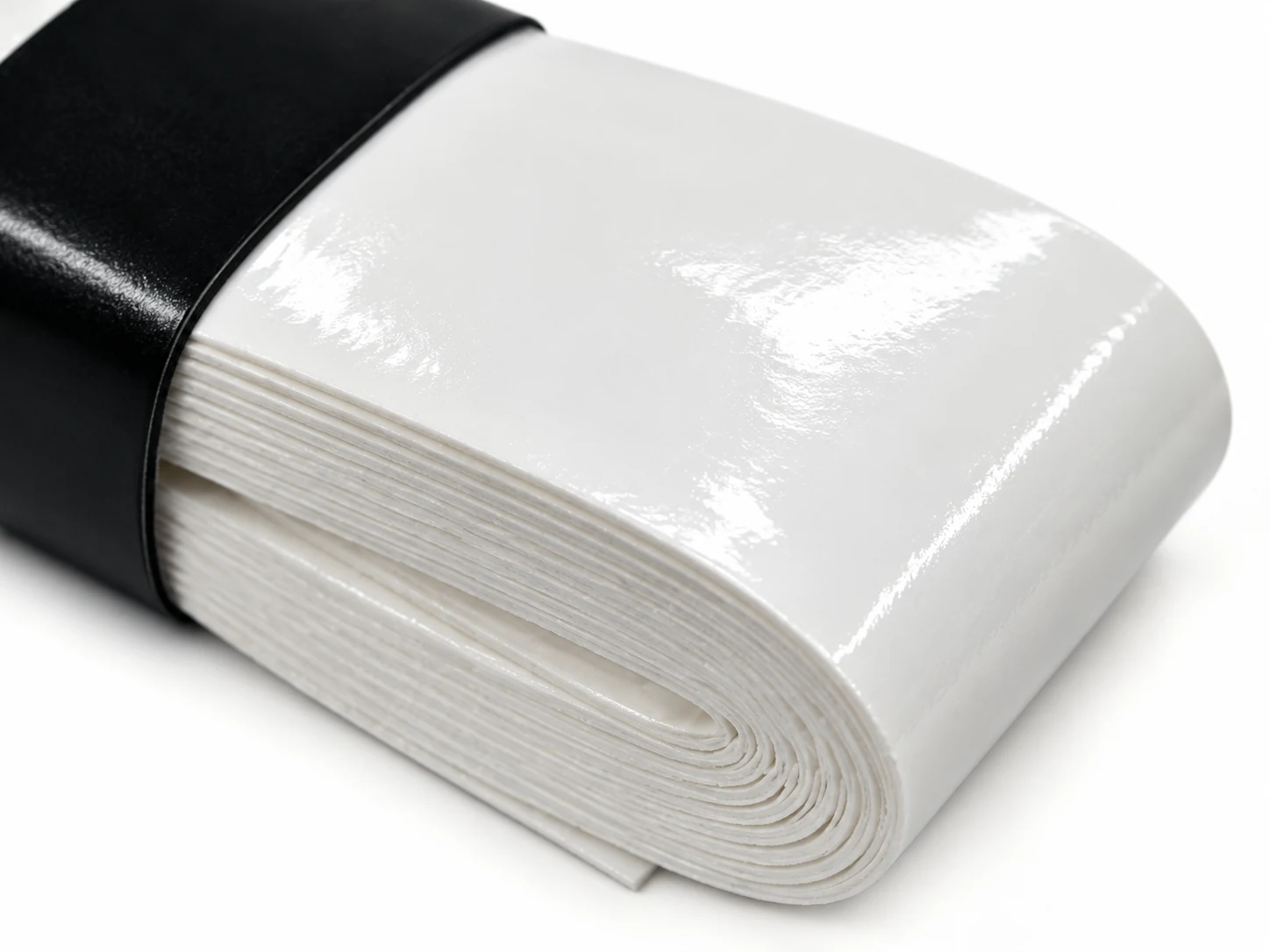 Close-up of the OG-WT01 white wet tacky overgrip surface and roll edge