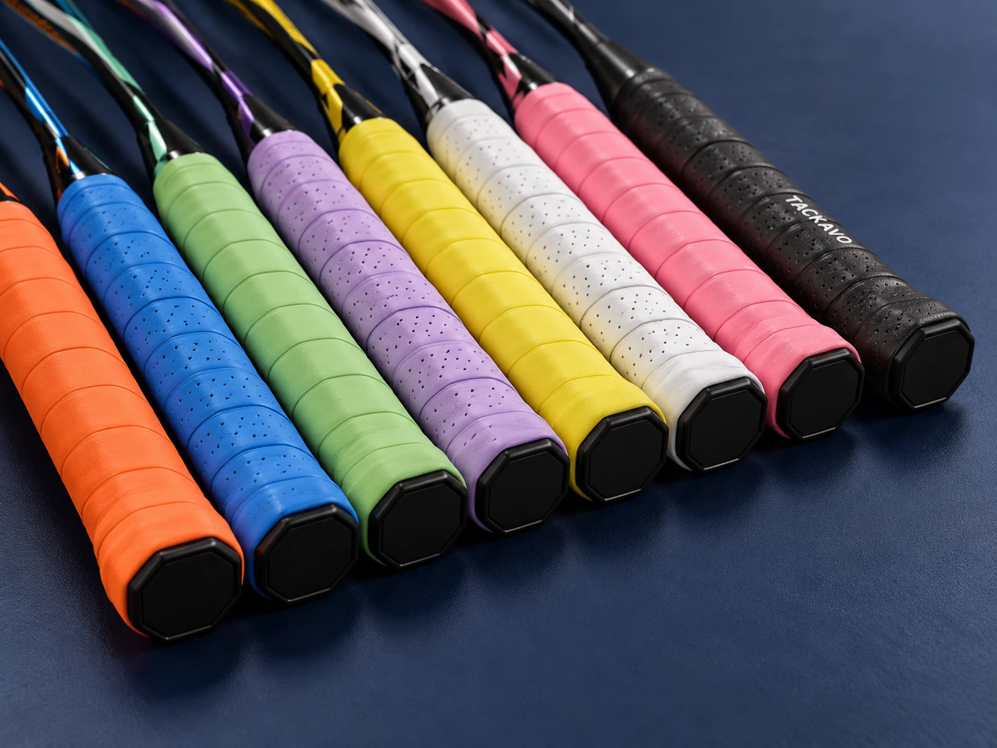Multicolor wrapped racket handles showing smooth, perforated and printed grips