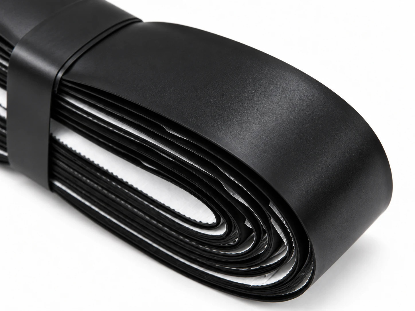 Close-up of the RG-F01 black firm replacement grip surface and roll edge