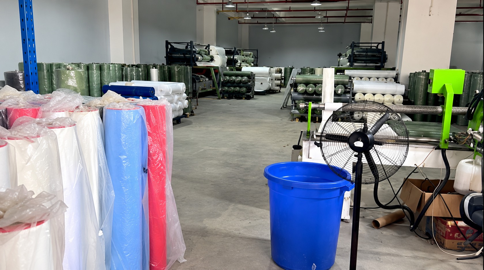Workshop with material rolls and processing equipment